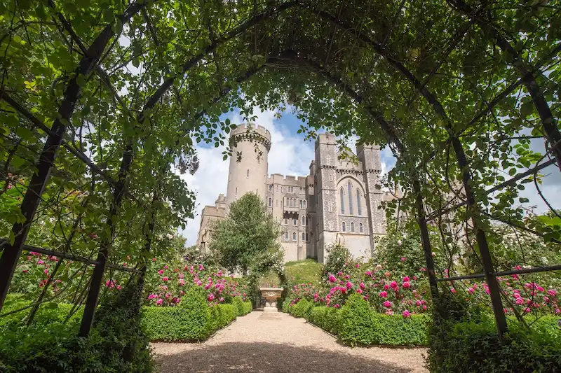 View of Arundel Castle framed by a garden archway in West Sussex