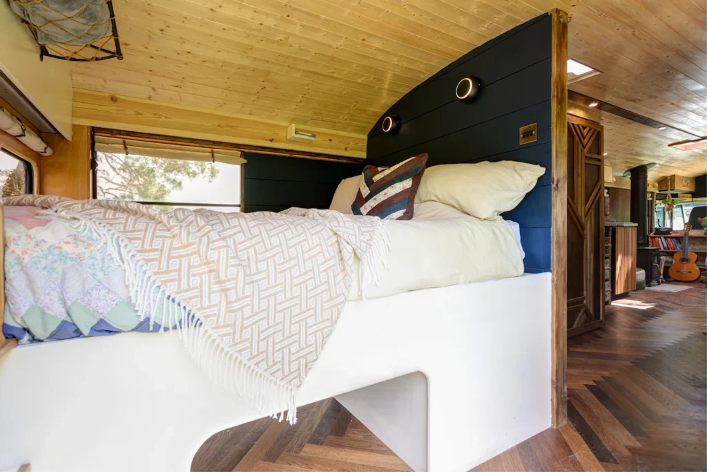 Cabin-style interior and king size bed in the Skoolie bus for digital detox stays