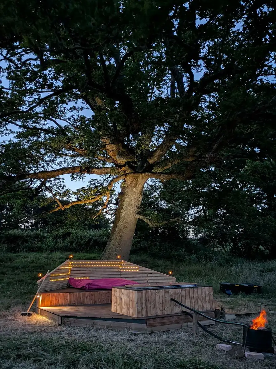 Wood-fired hot tub steaming during a digital detox retreat in West Sussex