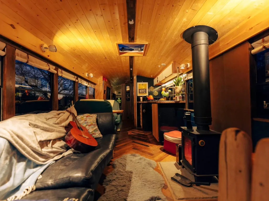 Warm interior details inside the Skoolie Stays glamping bus