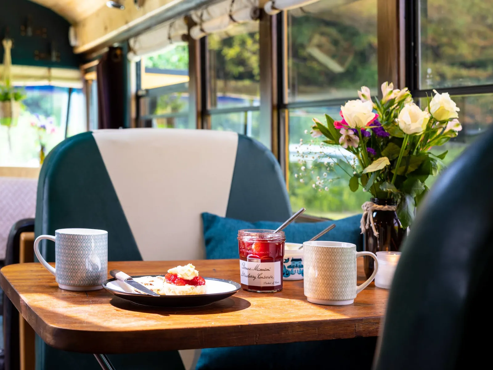 Dining area set for breakfast inside the Skoolie Stays bus