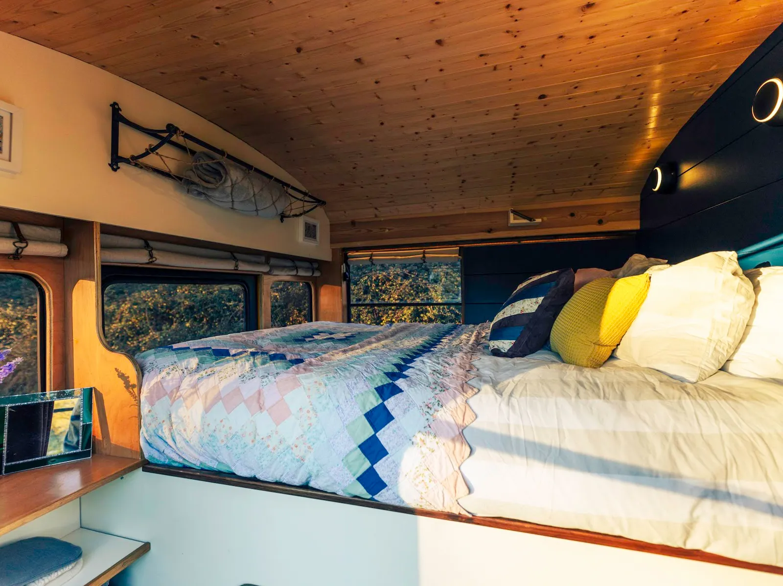 King-size bed inside the Skoolie Stays converted school bus