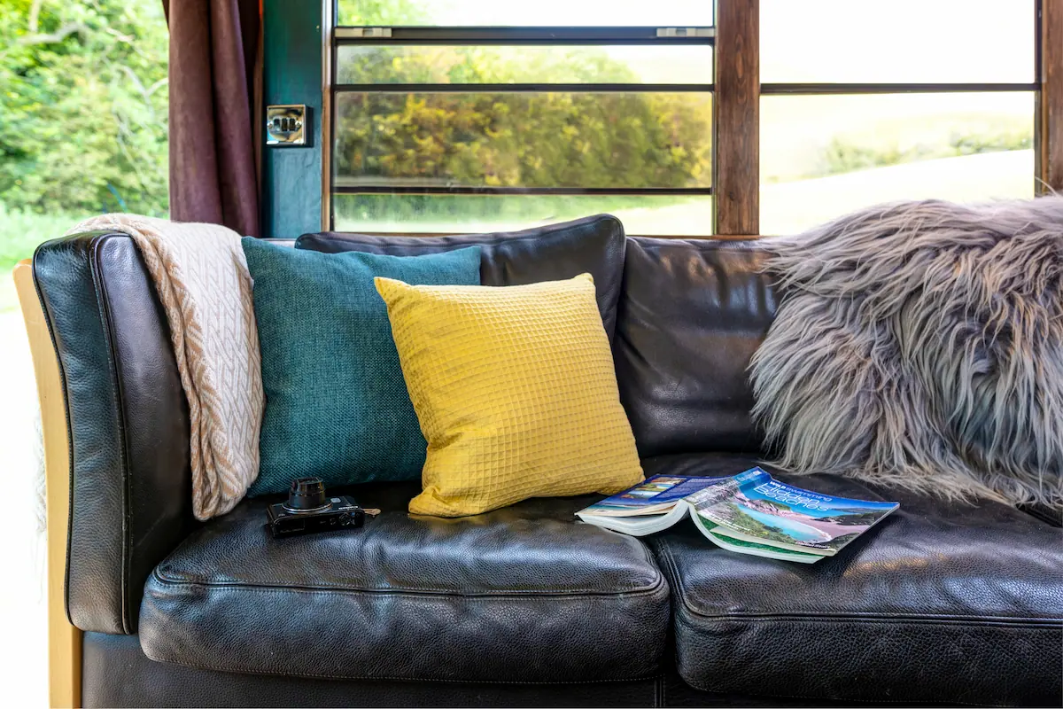 comfortable stylish sofa in skoolie stays glamping bus