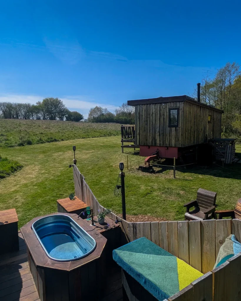 Private wood-fired hot tub beside The Vacationist Eco-Cabin in a secluded Sussex meadow