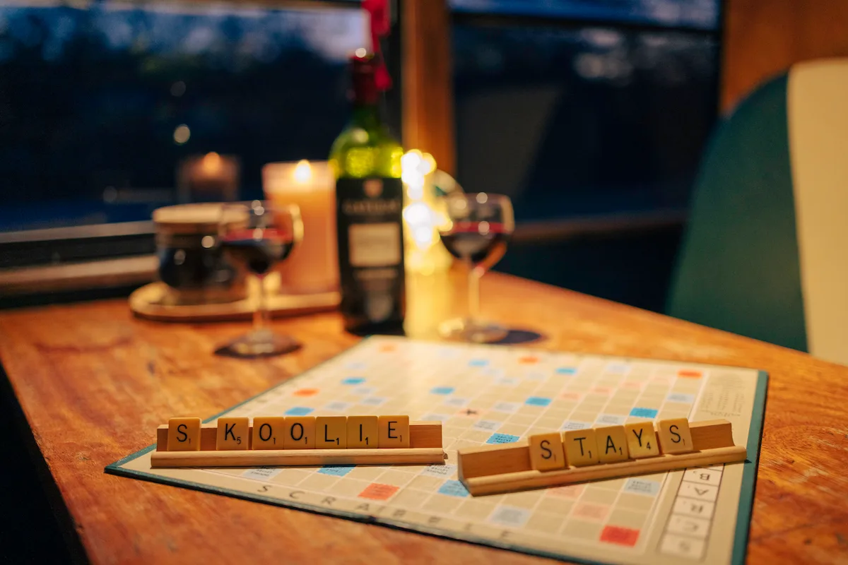 Board game and wine during a two-night digital detox break at Skoolie Stays