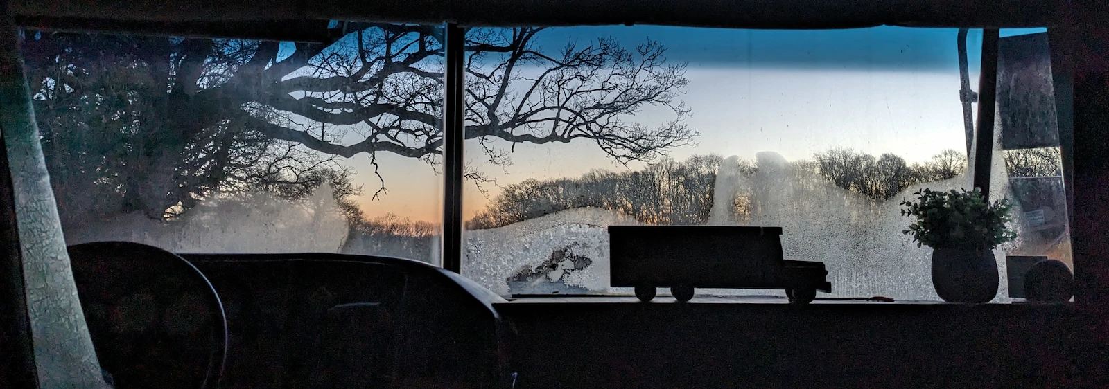 Winter countryside view from inside the Skoolie Stays school bus in Sussex